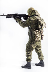 Members of the special purpose unit. A Russian special forces soldier with assault rifle aiming from a machine gun on a white background
