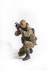 Members of the special purpose unit. A Russian special forces soldier with assault rifle aiming from a machine gun on a white background