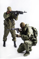 Members of the special purpose unit. Two Russian special forces soldiers with AK assault rifles in camouflage.
Portrait on a white background.