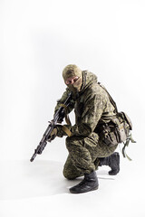 Members of the special purpose unit. A Russian special forces soldier with assault rifle aiming from a machine gun on a white background