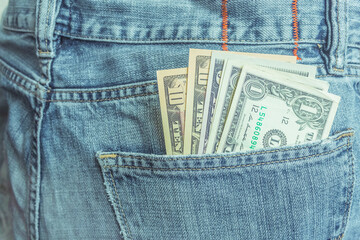 american dollars in back pocket of denim jeans