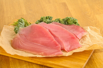 Raw salted tuna slice over board