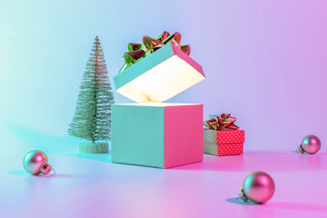 Neon xmas winter background. Open Christmas gift box with shine lights, minimal tree. Holiday...