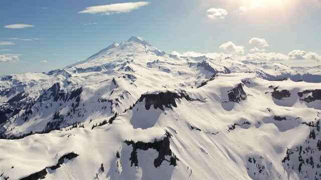 Iconic Mt Baker Volcanic Peak Aerial Dolly with Blue Sky in Spring Sun