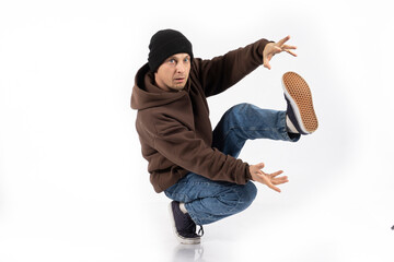 A break dance dancer in a hip-hop dance stand stands on his hands isolated on a white background. Bboy.