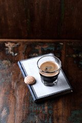 Coffee in glass cup on rustic wooden background. Copy space. 