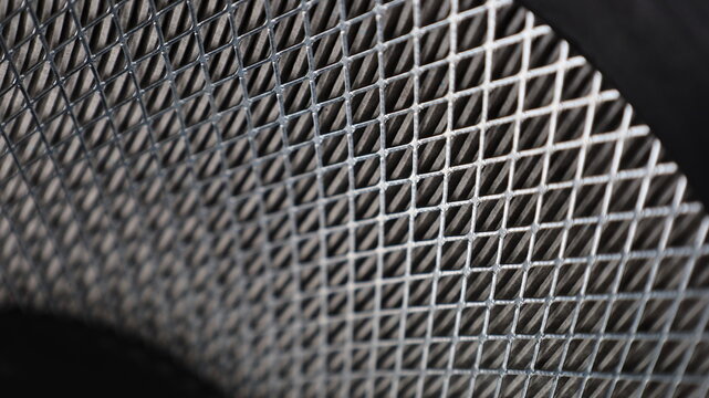 Curved wire mesh in the air filter. Choose to focus on the subject closely.
