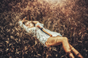 girl playing on shaman flute in the nature. © jozefklopacka