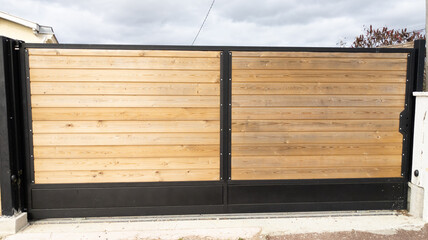 Brown entry wooden gate closed of private house suburb wood portal access home door