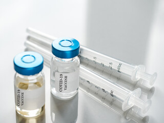 Syringes, injection bottles and tablets lying on the table. Close-up, indoors, view from above. Day light, studio photo. Healthcare concept