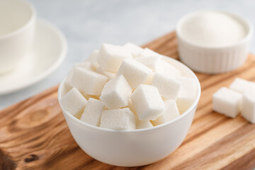 White granulated sugar and sugar cubes