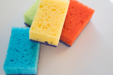 Multi-colored foam sponges for washing dishes. There are a lot of germs on the dish sponge. The source of diseases.