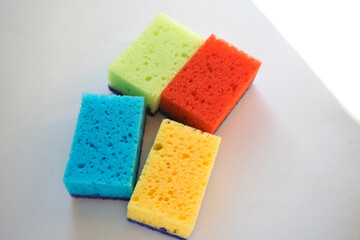 Multi-colored foam sponges for washing dishes. There are a lot of germs on the dish sponge. The source of diseases.