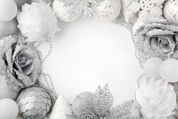 Christmas decor. White and silver colors. Monochrome. Christmas balls, decorations on a white background. Top view. Space for text.
