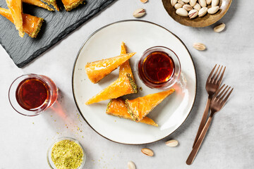 Traditional Turkish  dessert Baklava with pistachio served with black turkish tea. top view