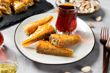 Traditional Turkish  dessert Baklava with pistachio served with black turkish tea.