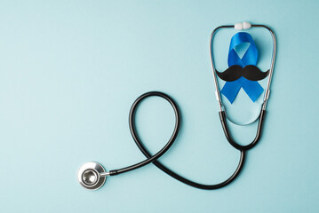 Top view photo of stethoscope and blue ribbon with mustache shape symbol of prostate cancer awareness on isolated pastel blue background with copyspace