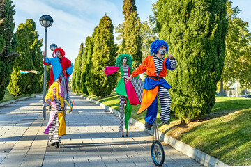 Talented clowns performing tricks on pathway in park © JoseIMartin