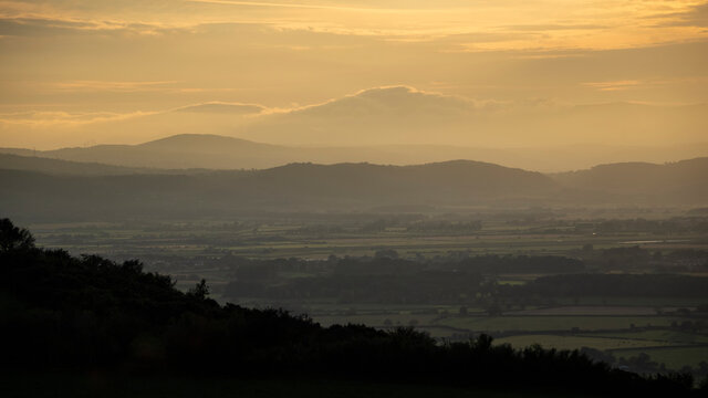 Stunning landscape sunset image of Snowdonia National Park mountains viewed from the hills above Prestatyn