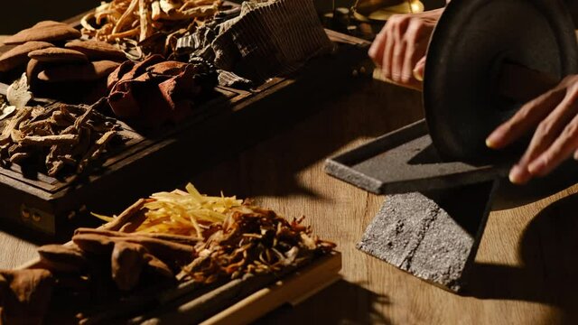 Closeup view of doctor working with herb and species mushroom anise turmeric in a table for traditional medicine advertising 