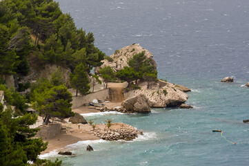 Zatoka z plażą wielkie głazy z błękitną wodą krajobraz nadmorski © Monika