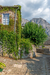 Traditional architecture with  stone buildings and  astraka mountain as background during  fall season in the village Papigo in zagori Greece