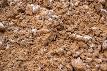 Textural sand, with  relief surface, multi-colored layers and different in size of granules, in outdoor sand career, after mining ore and sand for construction.