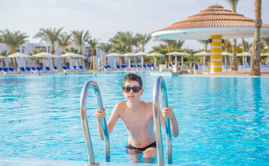 Boy rest in vacation. Teenage boy in swimming pool, Children lifestyle. Enjoy the life