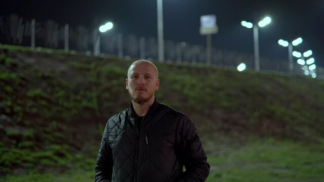 Russia,Yamalo-Nenets Autonomous Okrug, Novy Urengoy city, October 17, 2021, 22:00, a 35-year-old guy smokes a cigarette in the courtyard of a house in the Vostochny microdistrict at his white car