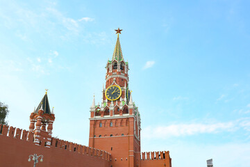 Fototapeta na wymiar Moscow Kremlin, Red Square. Spasskaya (Savior's) clock tower decorated by the red ruby star on the top of it. Blue sky background. UNESCO World Heritage Site. Copy Space