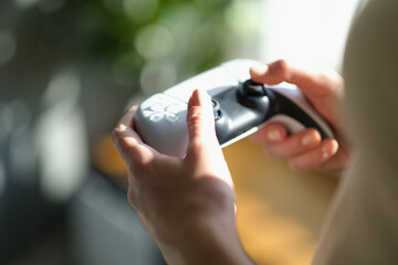 Female hands holding a joystick for the game, close-up