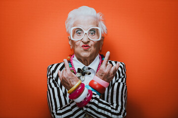 Funny grandmother portraits. Senior old woman dressing elegant for a special event. granny fashion model on colored backgrounds - obrazy, fototapety, plakaty