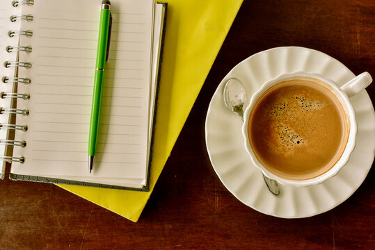 White coffee cup on wood table with light shade on tabletop