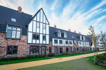 Fototapeta na wymiar Modern houses in cottage style in new residential estate 
