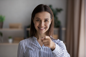 Head shot smiling young beautiful female hr manager pointing finger at camera, making choice, employing job applicant, needs you for corporate career, professional human resources recruitment concept.