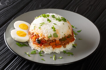 Peruvian rice with ground beef and various seasonal vegetables close-up in a plate on the table. horizontal