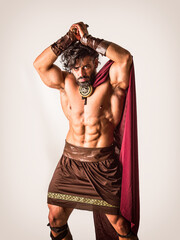 Muscular man posing in roman gladiator costume