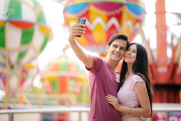 young woman and man couple person having fun and enjoy dating lifestyle at amusement theme park