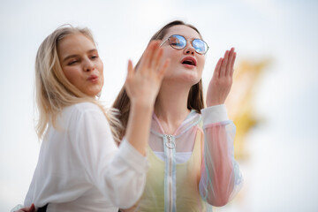 young woman having fun and happy smiling together at amusement theme park outdoor