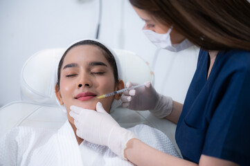 Naklejka premium young Asian woman making cosmetology treatment skin injection, Mesotherapy of face beauty care