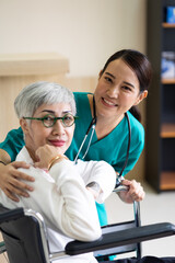 Fototapeta premium caregiver and elderly home care. Asian woman doctor or nurse talking with senior patient.