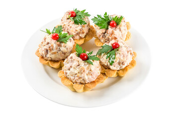 Banquet food. Mini tartlets stuffed with salad and pate in a plate isolated on white background