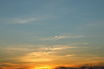 Obraz premium Heaven at early morning with copy space. Sunset, sunrise backdrop.Predawn clear sky with orange horizon and blue atmosphere. Smooth orange blue gradient of dawn sky.