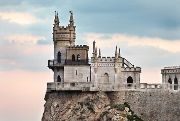 Fototapeta na wymiar Beautiful gothic castle Swallow's Nest on a 40-meter cliff of Cape Ai-Todor above the Black Sea in the village of Gaspra, Yalta region of Crimea. The main attraction of the Crimean peninsula
