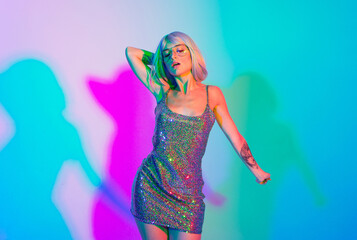 Young woman with pink hair dancing and having fun