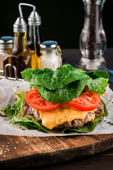 burger with cutlet and cheese wrapped in lettuce leaves without a bun
