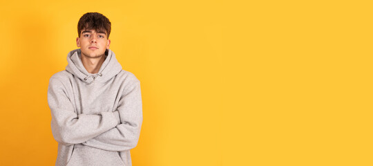 portrait of teen boy isolated on yellow background