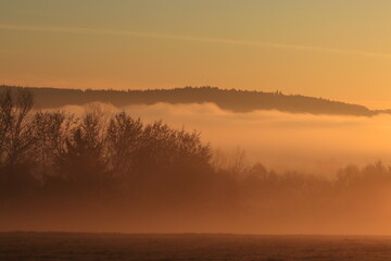 misty sunrise over a village