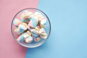 marshmallow candy in a bowl on blue 