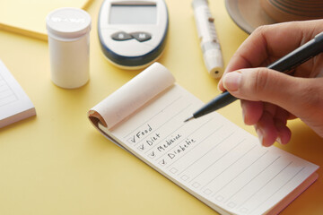 check mark on a check box on a paper with glucose meter on table 